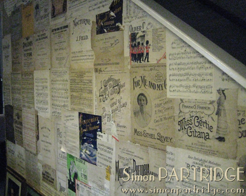 Vintage sheet music decoarating the wall of Sheena Holland's shop