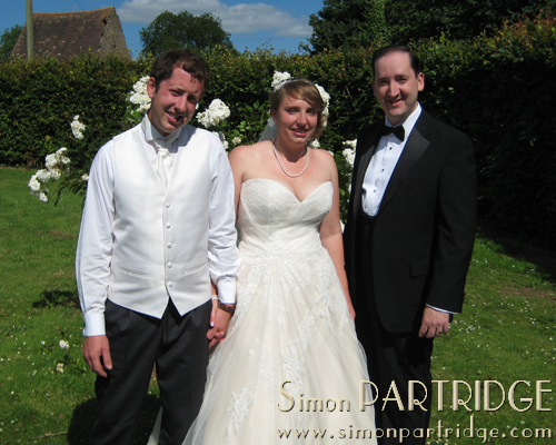 Bride and groom Amie and Chris with Simon Partridge